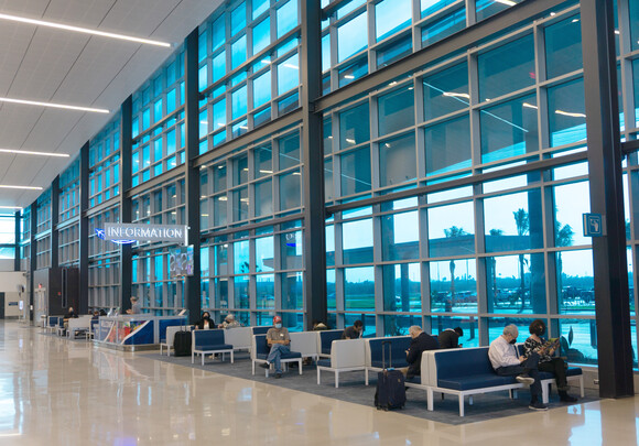 Interior of airport building at gate with custom smart glass windows. 