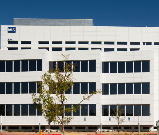 Exterior of white building with custom smart glass windows.