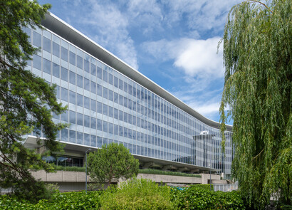 Building facade with smart windows from left to right on a large modern glass building.