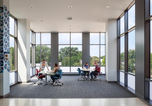 Interior common space of office building with huge smart glass windows from left to right. 
